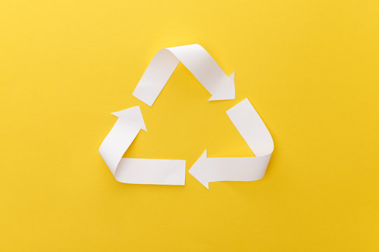 top view of paper craft triangle on yellow background