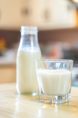 Reptientes with milk on a wooden table and rustic kitchen background. Alternative milk concept. Front view. Horizontal composition