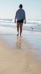 young woman walking at the beach
