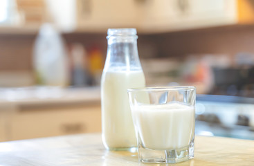 Reptientes with milk on a wooden table and rustic kitchen background. Alternative milk concept. Front view. Horizontal composition