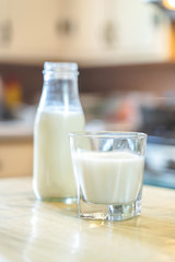 Reptientes with milk on a wooden table and rustic kitchen background. Alternative milk concept. Front view. Horizontal composition