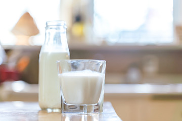 Reptientes with milk on a wooden table and rustic kitchen background. Alternative milk concept. Front view. Horizontal composition