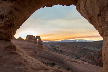 Sunrise over Delicate Arch in the Very Early Morning in Arches National Park, Perspective from another Arch, Utah, USA