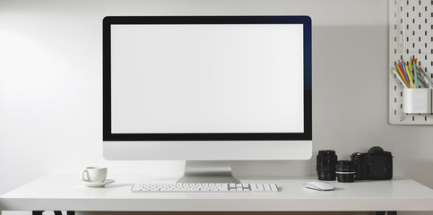 Mock up desktop computer with camera and office supplies in modern office style