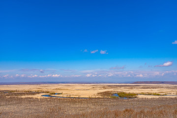 Obraz premium Kushiro Shitsugen national park in Hokkaido in spring day, view from Hosooka observation deck, the largest wetland in Japan. The park is known for its wetlands ecosystems