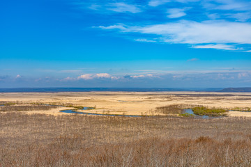 Fototapeta na wymiar Kushiro Shitsugen national park in Hokkaido in spring day, view from Hosooka observation deck, the largest wetland in Japan. The park is known for its wetlands ecosystems