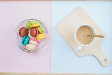 Macaroon desserts in a colorful, mouthwatering bowl paired with a sweet, fragrant coffee.