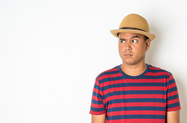 Asian men around the age of 27-35 are thinking and making faces, confused, not understanding, wondering with something. This photo was taken in the studio. With a white background