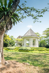 Beautiful pavilion In a garden full of green trees