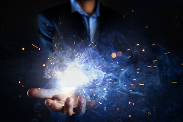 businessman holds fire in his hands.
