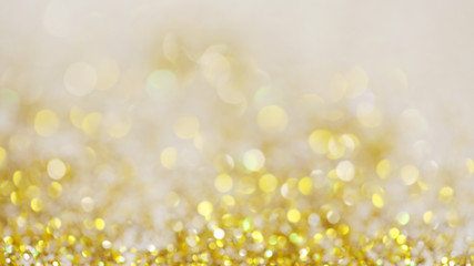 Lights on gold with star bokeh background.Gold celebration background for anniversary, New Year Eve, Christmas, falling coins, wedding or birthday