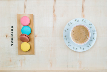 The background is full of desserts, macarons and delicious coffee.