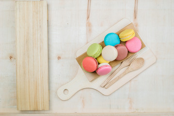 The background is full of macarons decorated with ornamental plants.