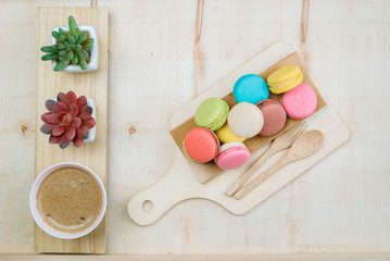 The background is full of desserts, macarons and delicious coffee.