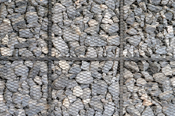 Stone wall in metallic grid net cage as background or texture