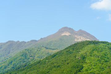 Fototapeta na wymiar Green mountian in sunny day,clear blue sky with white clouds, view Yufu, Yufuin Cho Kawakami, Yufu, Oita Prefecture,Japan.