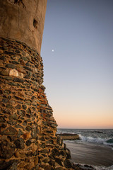 lighthouse on beach at sunset