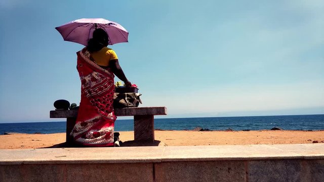 Lady sells eatables- Pondicherry  beach,India.