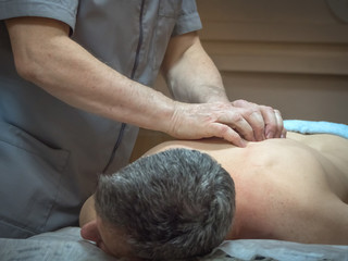 Obraz na płótnie Canvas Physiotherapist massaging male patient. Injury treatment.