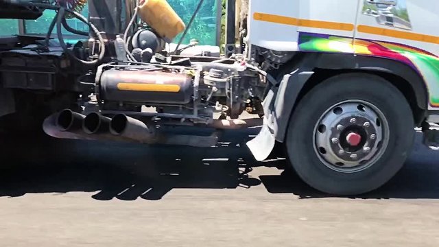 A spinning wheel of a truck on highway. Detail of a rotating wheel of a truck, slow motion.