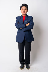 Full body shot of mature Asian businesswoman with arms crossed