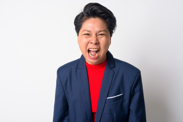 Portrait of angry mature Asian businesswoman shouting and screaming