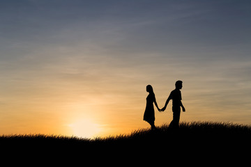 Fototapeta na wymiar Silhouettes of couple man and woman broken heart at nature sunset. Love concept.