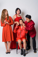 Group of diverse Asian friends in funny struggling situation together