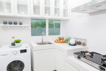 Modern white kitchen with counter and white details, minimalist interior, Full set of kitchen equipment