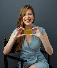 Young woman studio portrait with gold credit card.