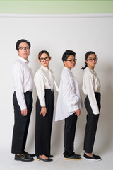 Profile view group shot of Asian business people looking at camera together