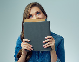 smiling woman student, teacher covered her face with book.