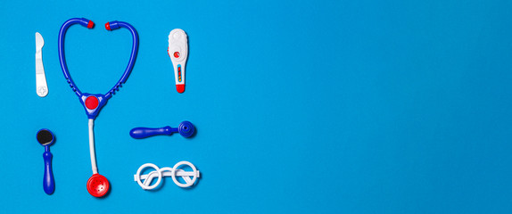 Top view of toys medical set on light blue background