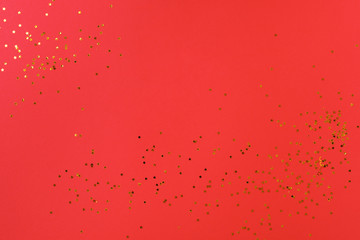 Red background with golden candy stars. Top view, minimal christmas style and holiday concept. Banner for the site.
