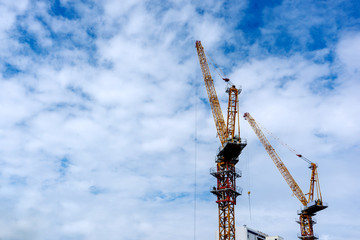 Fototapeta na wymiar Yellow iron crane machine with blue sky