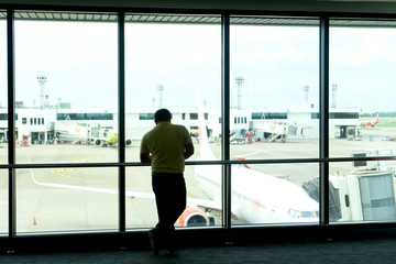 Fototapeta na wymiar Tourist wait for airplane flight to fly to the point at the terminal