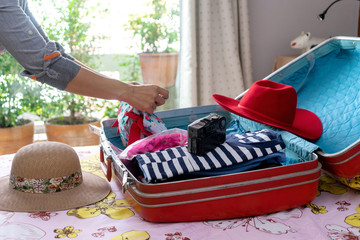 woman packing the luggage