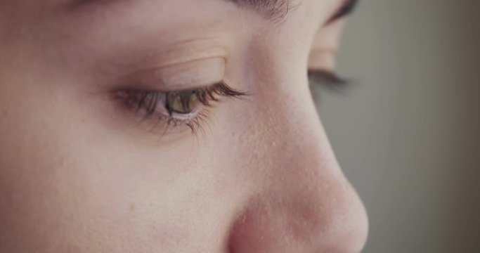 Close-up woman eyes cries and tears flow.