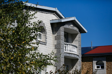 Beautiful country house behind a high fence. Chic cottage in a holiday village.
