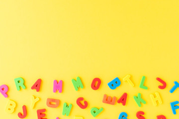 Colourful alphabet on yellow background. Language school concept
