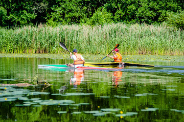 Two men floating in a canoe on the river 