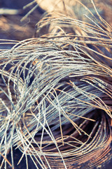 burnt tires. melted old rubber. metal rods stick out of the wheel.