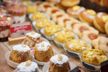 Donuts and rings. Hot pastries lie on the shelf in the cafe. Buns and muffins in the store.