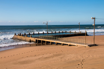 Footprints in Beach Sand Leading to Tidal Pool