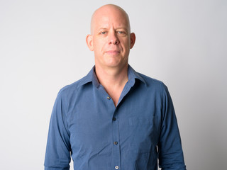 Face of mature handsome bald businessman looking at camera