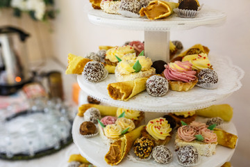 View of the served for decorated wedding dinner candy bar table with different sweet treats