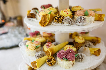 View of the served for decorated wedding dinner candy bar table with different sweet treats