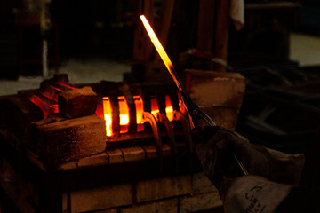 Hot steel bars placed in factory furnace.