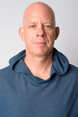 Obraz premium Face of mature handsome bald man wearing hoodie