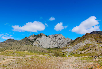 Fototapeta premium Landscape. Mountains, blue sky with clouds, forest, river. Beautiful background. Altai journey.